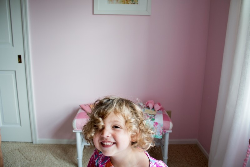 little girl with diy upholstered bench--see how to upholster a bench with this tutorial by DIY Decor Mom