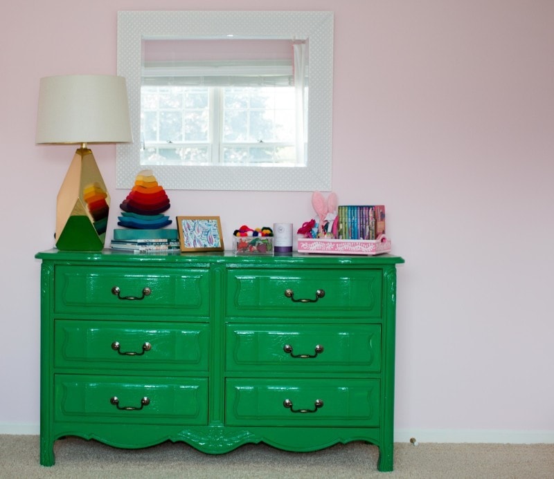 girls nursery with green vintage dresser