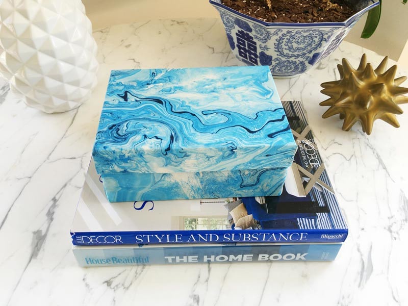 blue marble decorative box on top of a stack of books