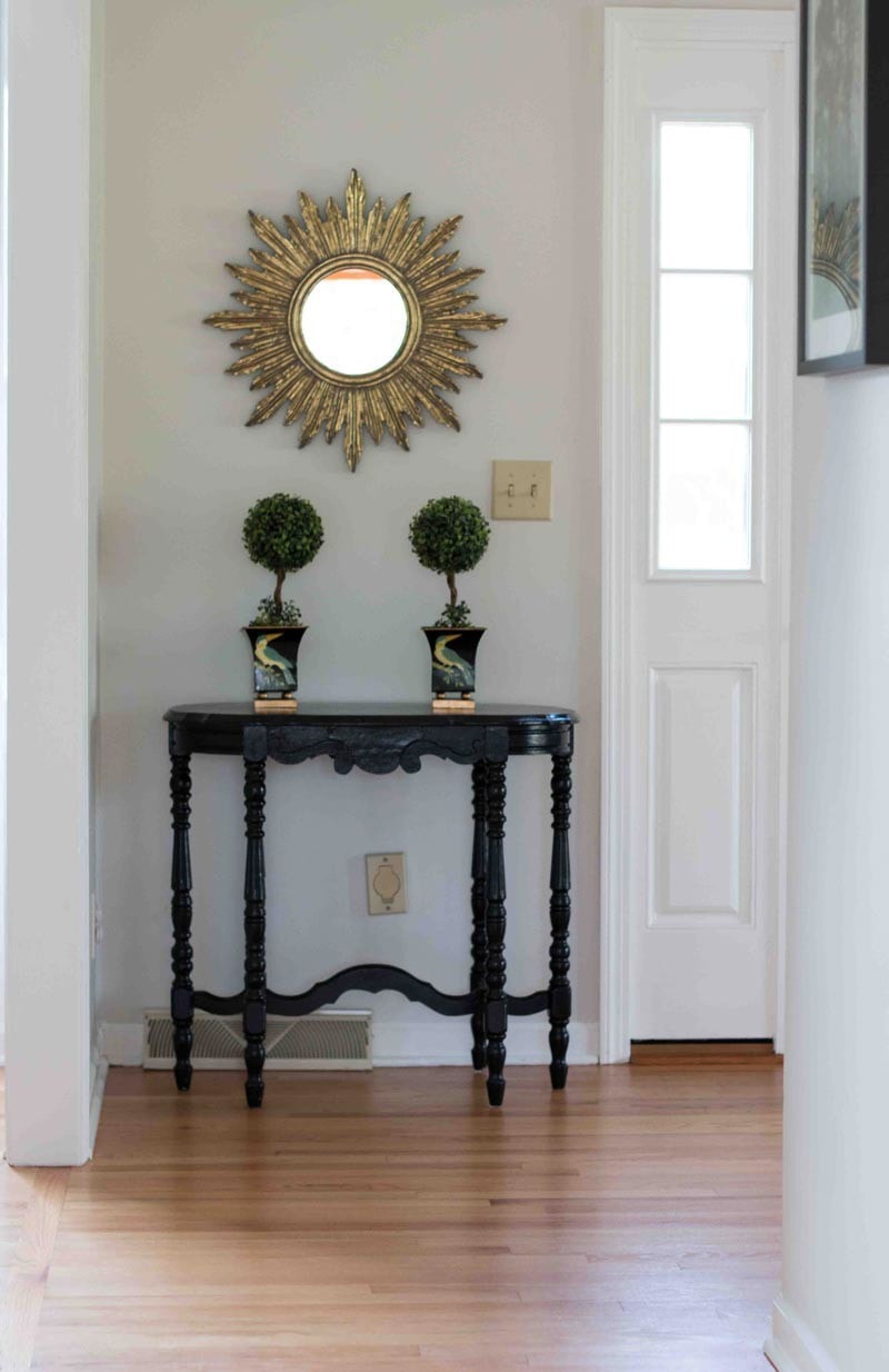 BM classic gray paint color on walls in foyer hallway with black table and Simply White trim