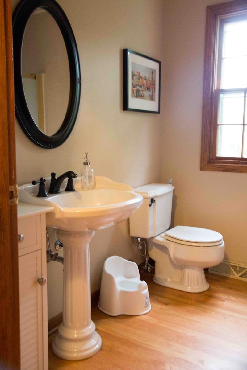 brown bathroom with pedestal sink before installing beadboard