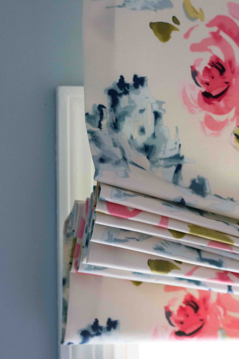 detail of DIY Roman Shade curtain layers using flowery fabric in small bathroom