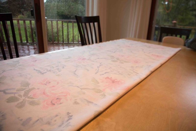 fabric laid out on table for DIY Roman Shades--instructions on how to make roman shades