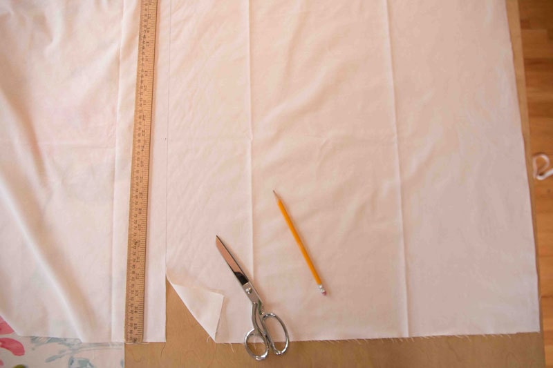 fabric with ruler pencil and fabric shears on table for making roman shades