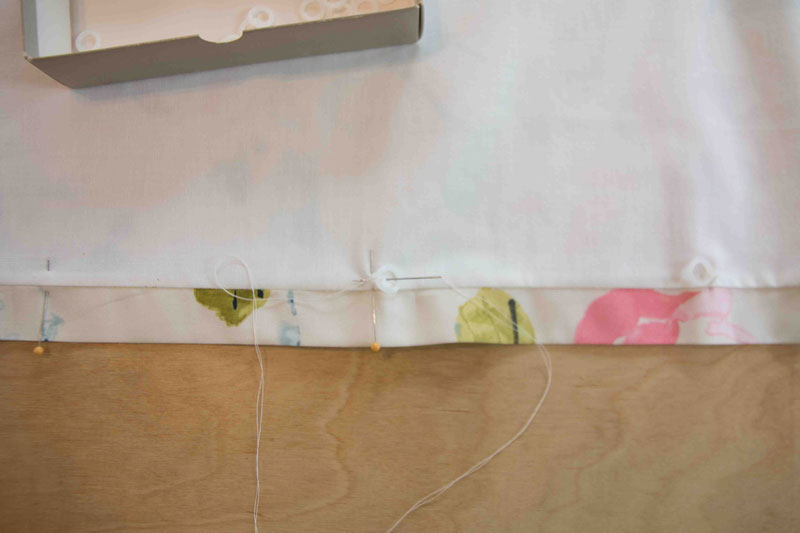 sewing upholstery hooks onto DIY Roman Shade with pins and needles