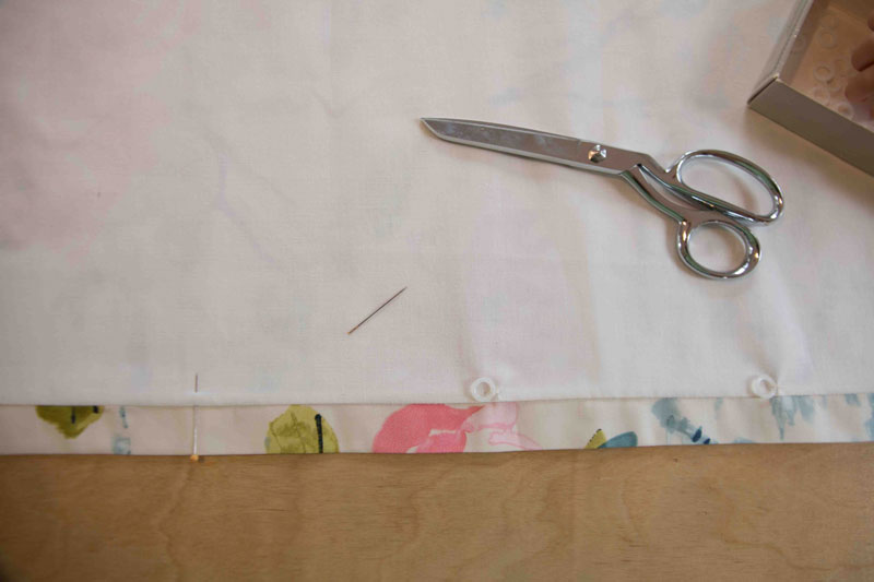 How to Make Roman Shades: picture of fabric with drapery hooks, pins, and fabric shears