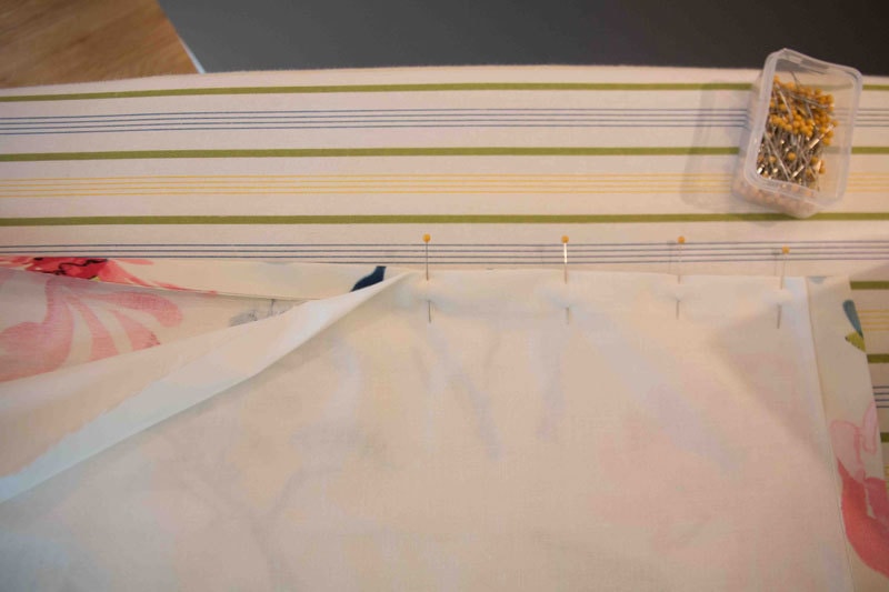 fabric and liner for DIY Roman Shade being held together by pins--tutorial on how making roman shades
