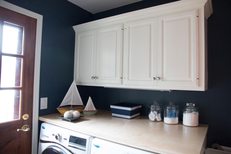 things to stock up on before baby comes--laundry detergent and household items in laundry room on countertop