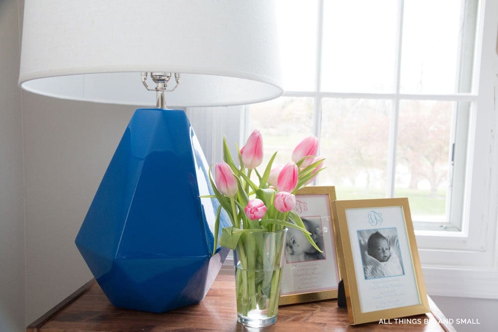 blue lamp in blue and white bedroom on bedside table