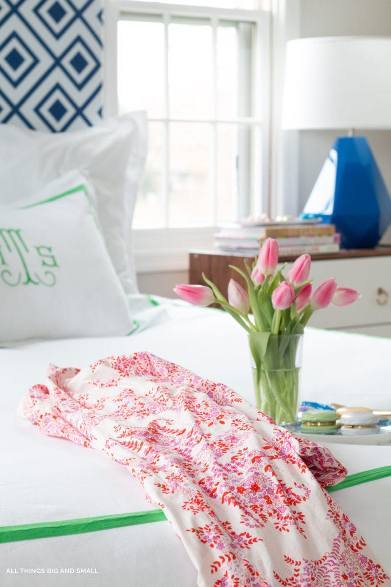 image of bed with flowers and a robe- important first trimester things to do 