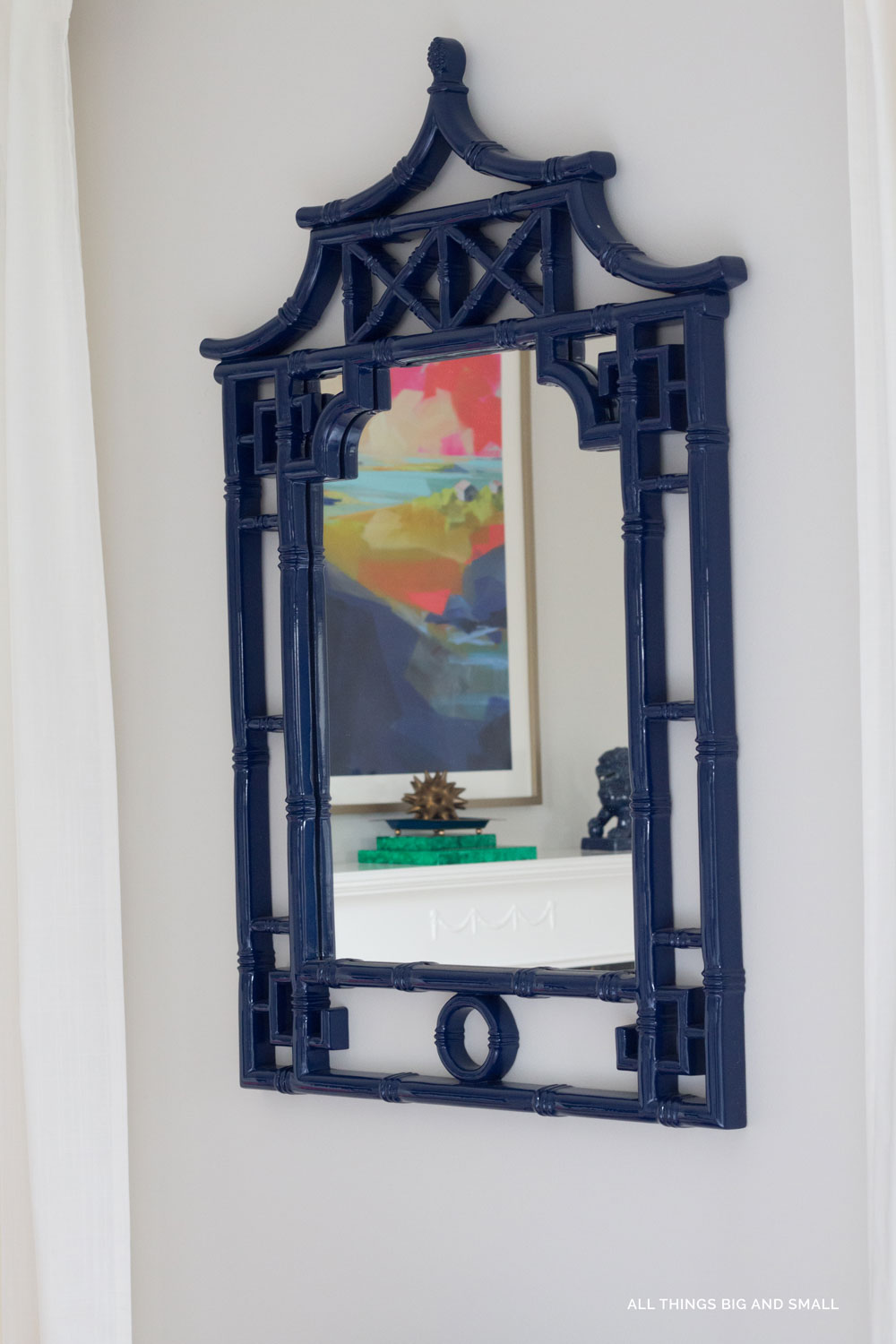 blue chinoiserie mirror on gray walls in blue and white master bedroom