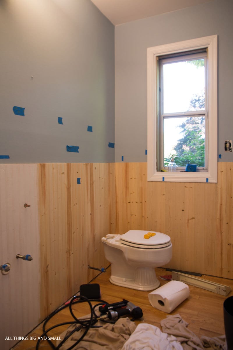 beadboard being installed in a bathroom half painted, half unpainted