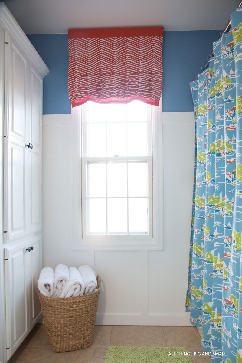 picture of DIY Roman Shades in bathroom with blue walls board and batten paneling for tutorial on how to make roman shades