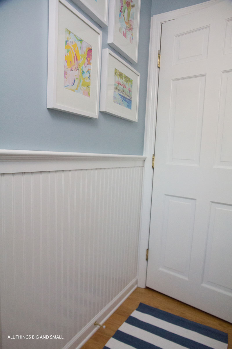 beadboard bathroom with blue walls and white beadboard