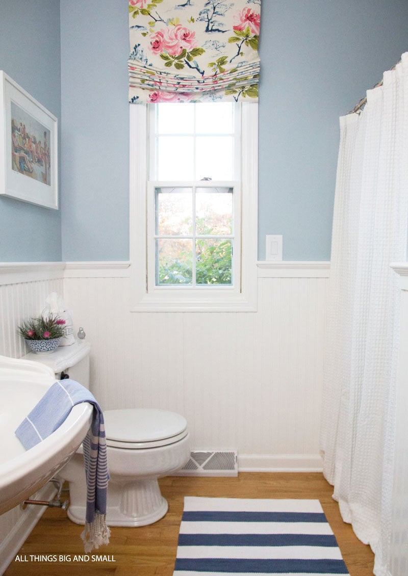 blue and white bathroom with colorful patterns showing how to mix and match fabrics