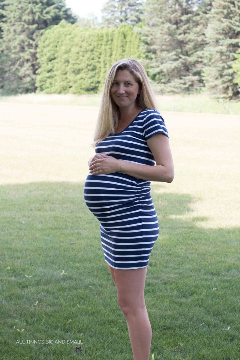 photo of pregnant woman in blue and white stripe dress--tips on hospital bag checklist for baby