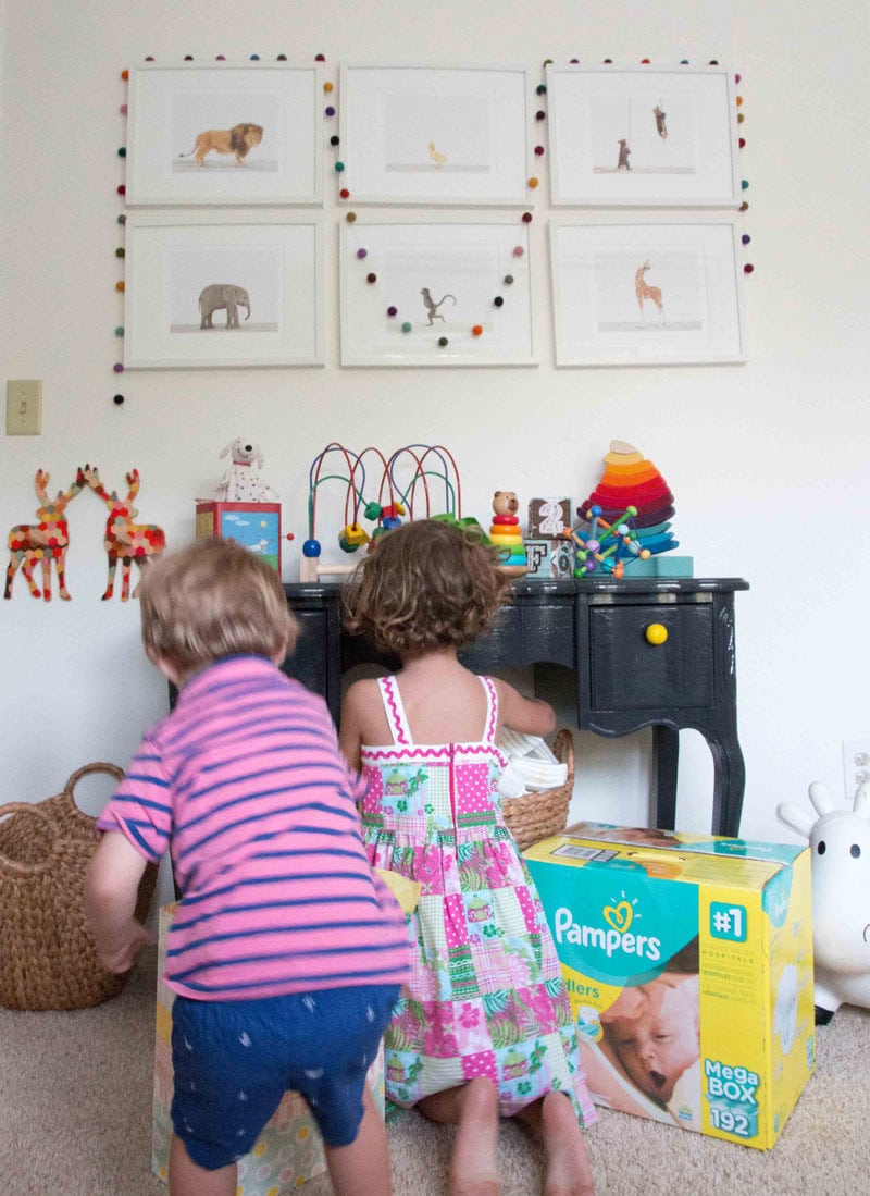 big brother and big sister prepare for new sibling and set up nursery