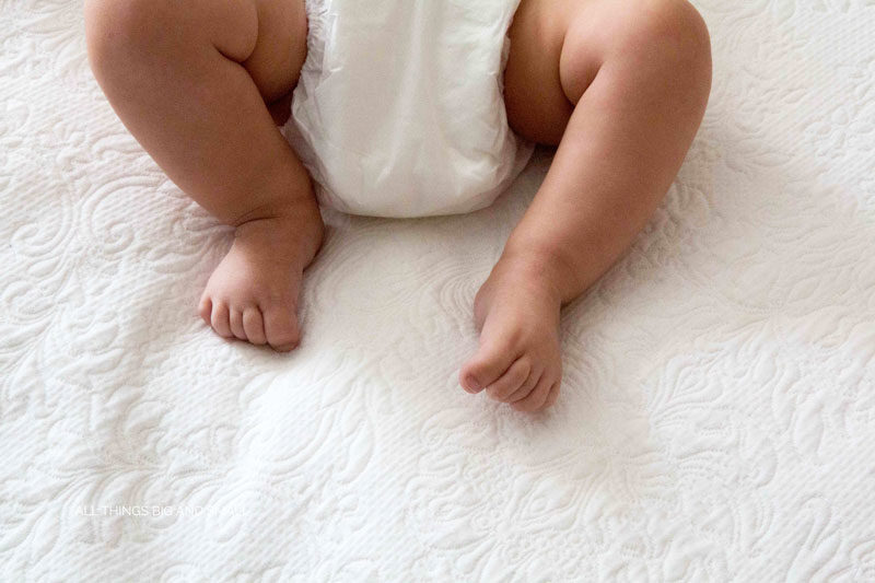 picture of newborn baby feet on white coverlet