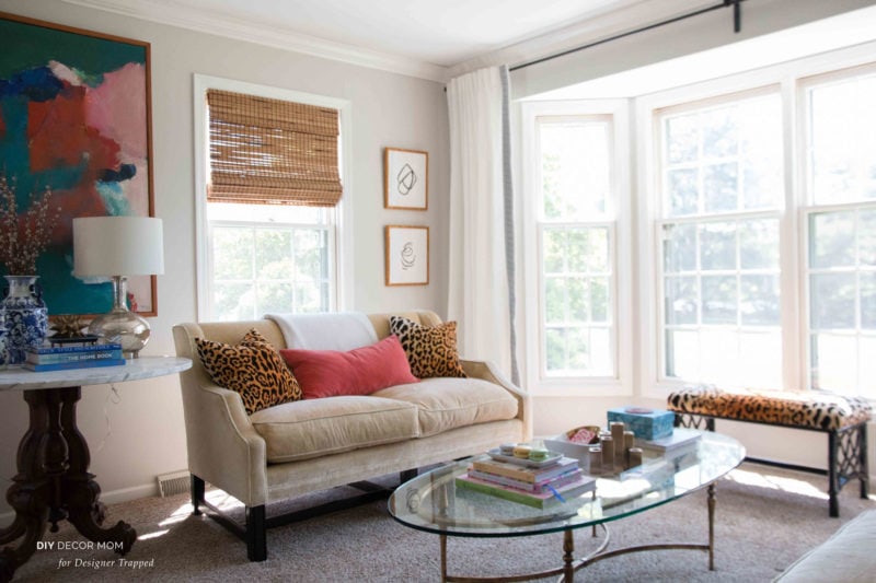 furniture arrangement in a small living room small sofa with bench in front of bay windows and glass coffee table