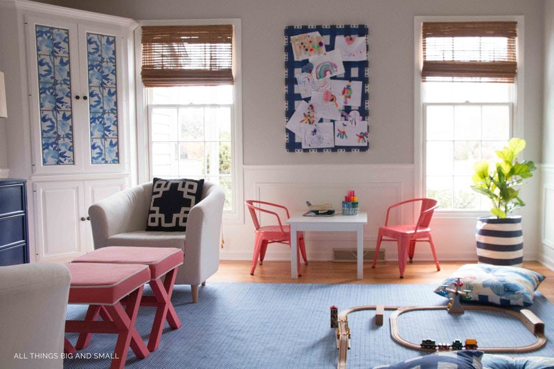 fabric bulletin board in playroom with childrens art