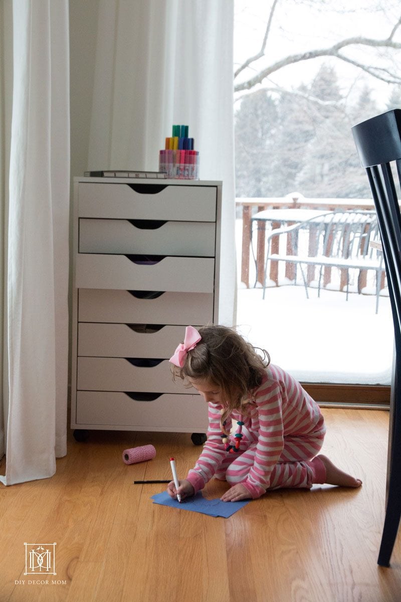 girl drawing on colored paper--summer routines and activities that keep them busy