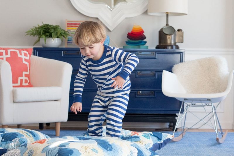 two year old boy jumping in playroom--see the best toys for 2 year old boys here