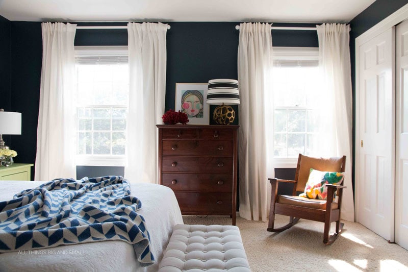 blue and white bedroom with navy blue walls