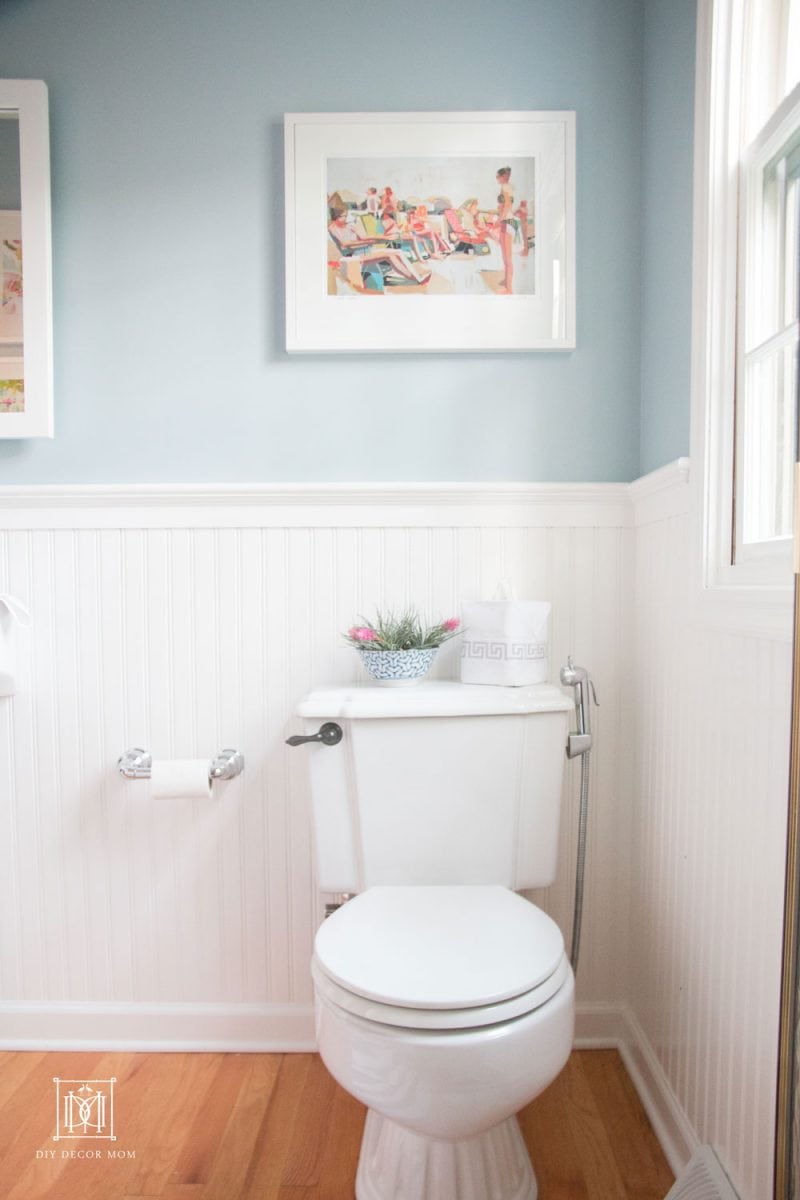 blue and white bathroom with white beadboard blue walls and white toilet