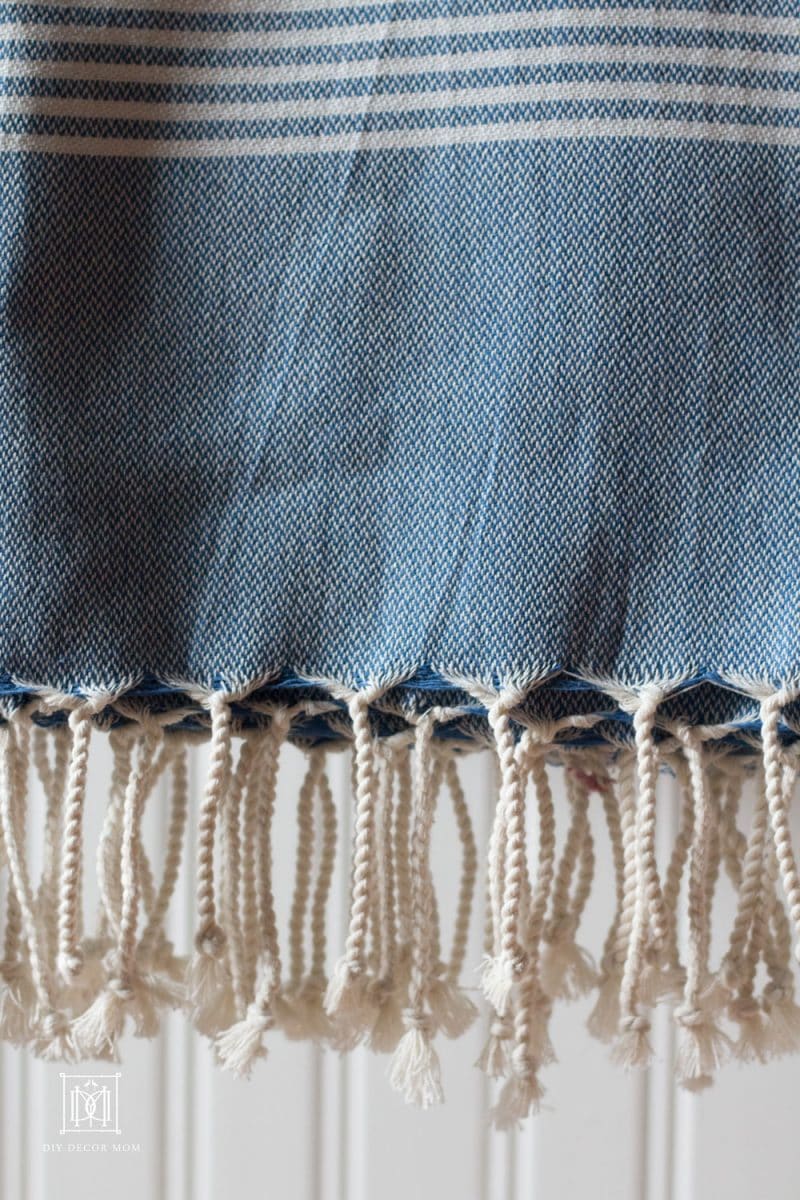 blue and white turkish towel and white beadboard bathroom