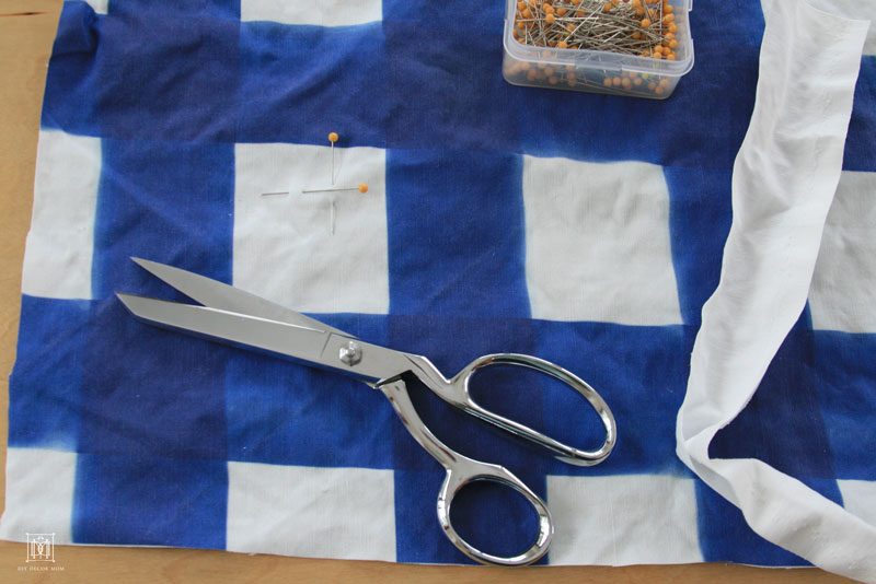 scissors and blue buffalo check fabric for DIY bulletin board