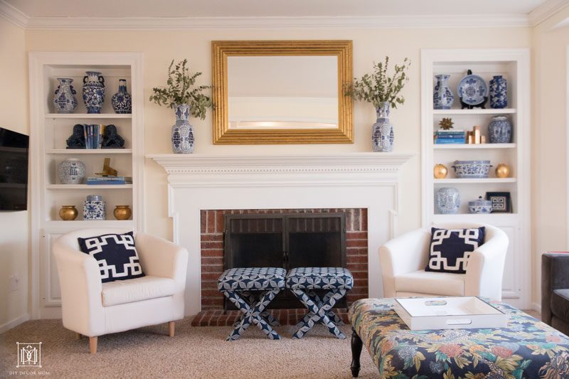 blue and white mantel with blue and white ginger jars and gold faux bamboo mirror