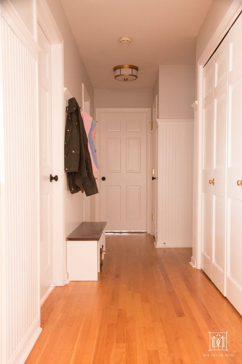 small mudroom in hallway entrance with beadboard