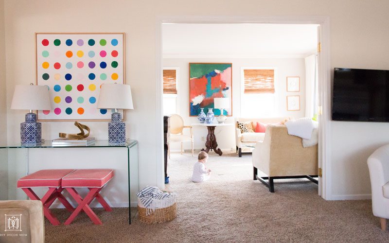 stylish glass console table and abstract art in living room