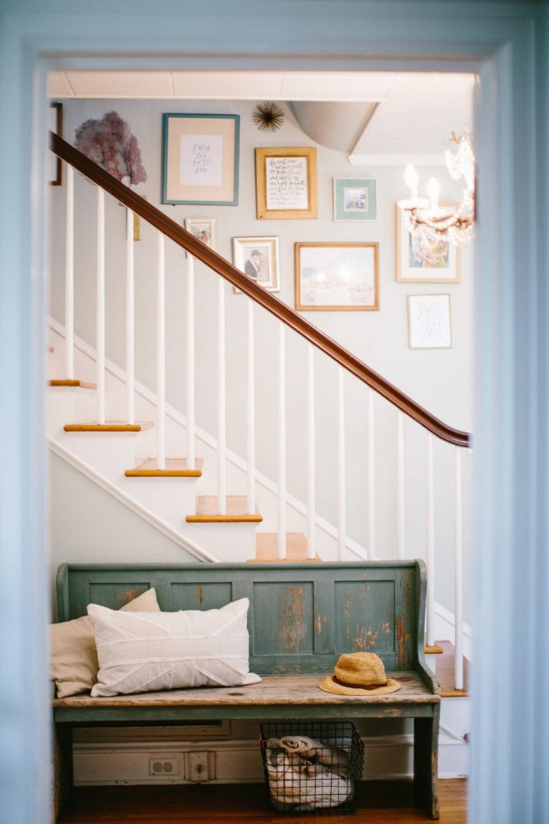 staircase with gallery wall and bench