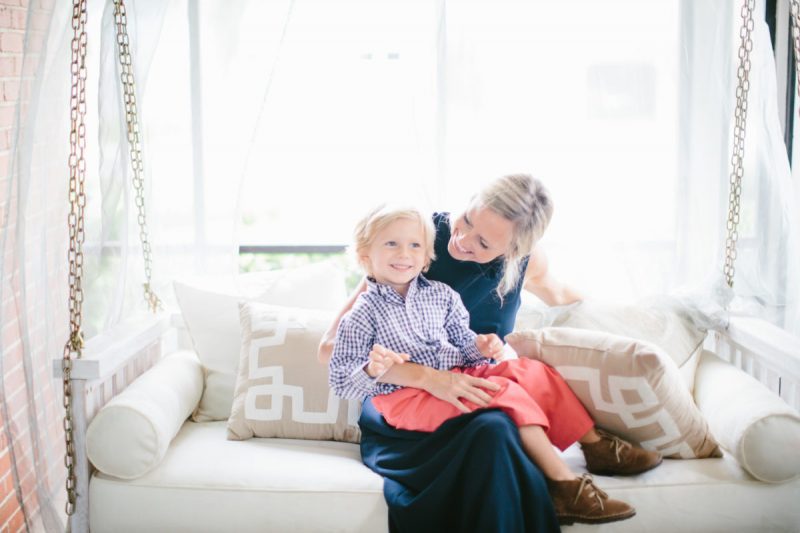 tips for decorating with kids- sarah tucker and son sitting on light colored couch
