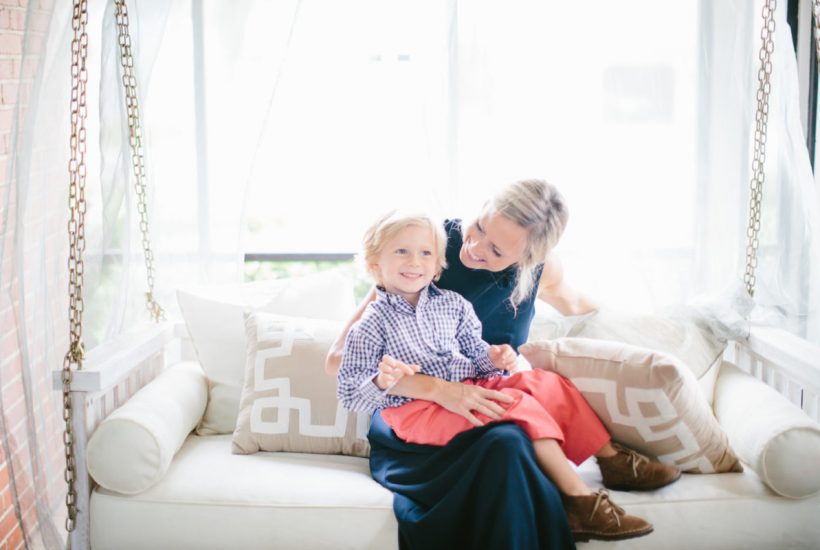 tips for decorating with kids- sarah tucker and son sitting on light colored couch