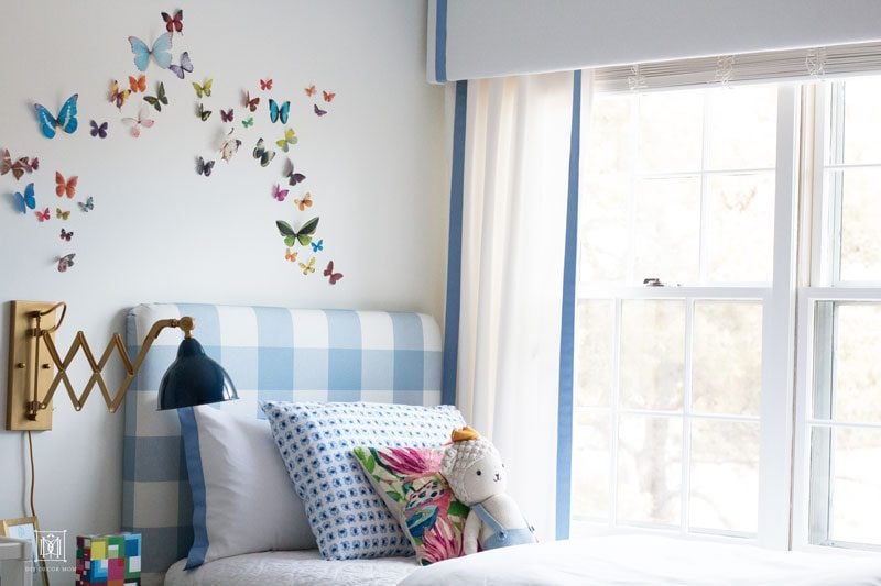 white window valance box with blue grosgrain curtains in bedroom