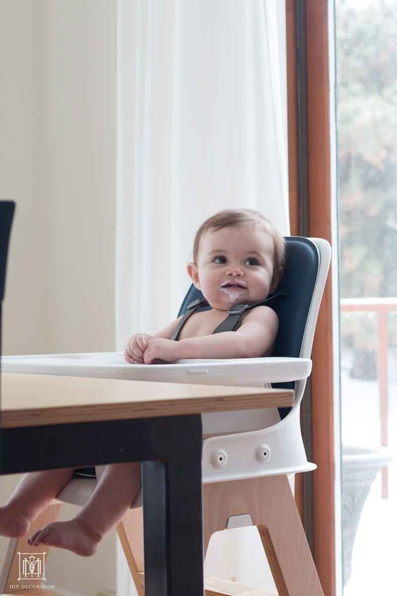 messy baby in clean high chair