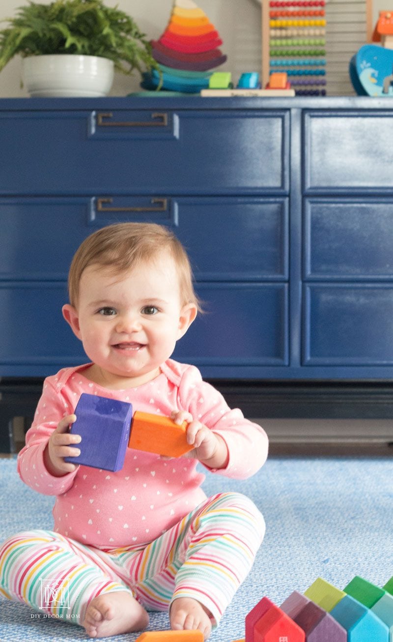 baby playing with blocks in playroom