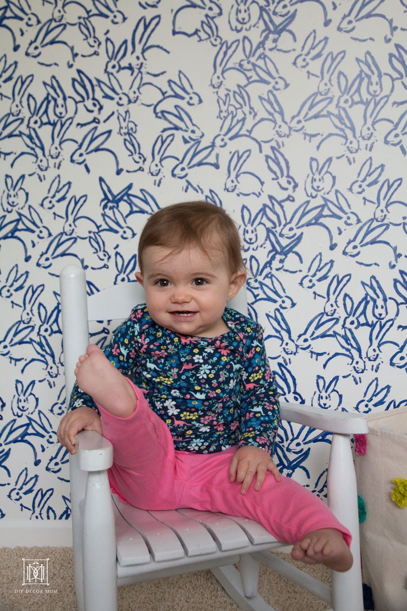 blue and white accent wall in nursery baby girl