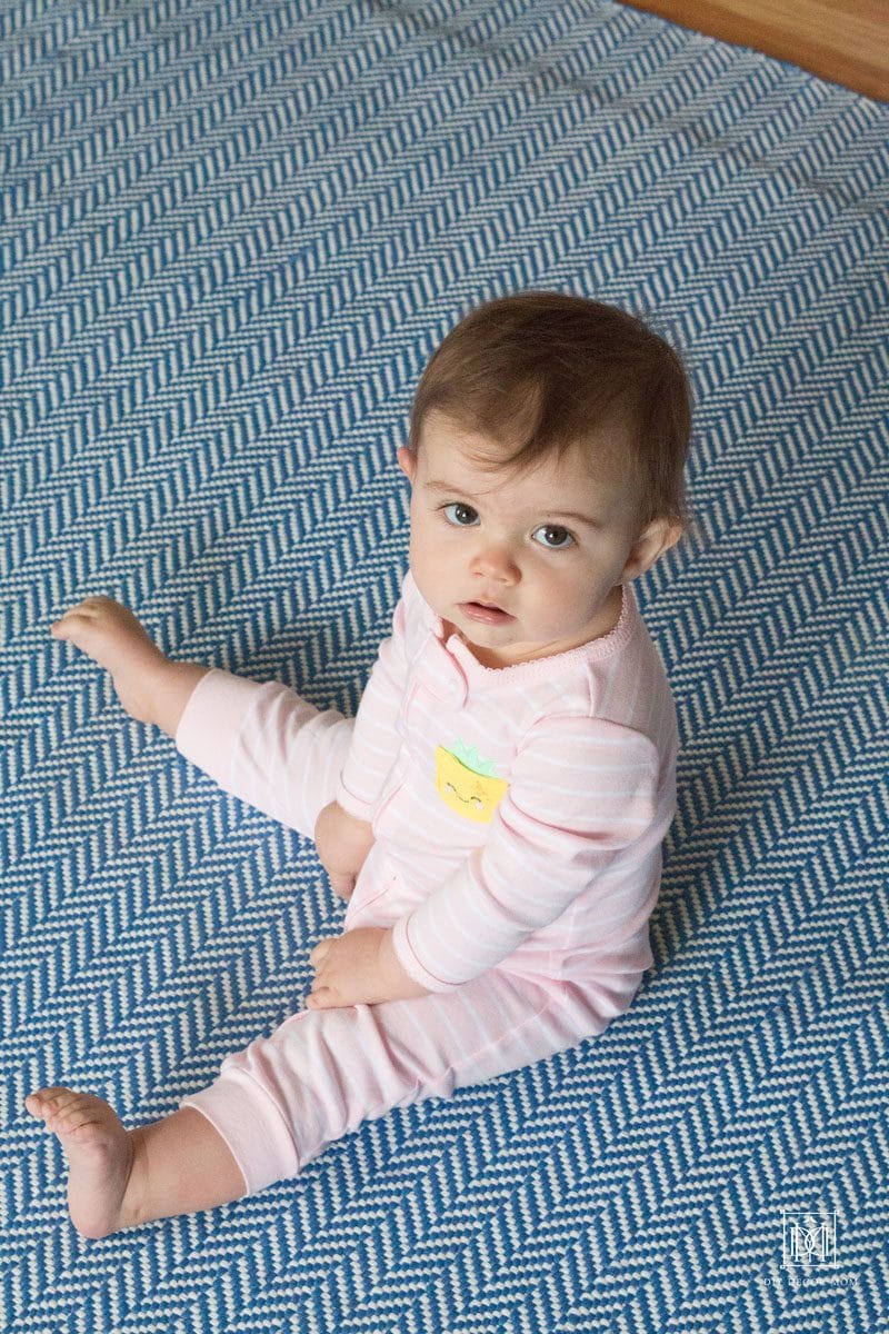 new mom tips from mom of three- baby girl sitting on floor