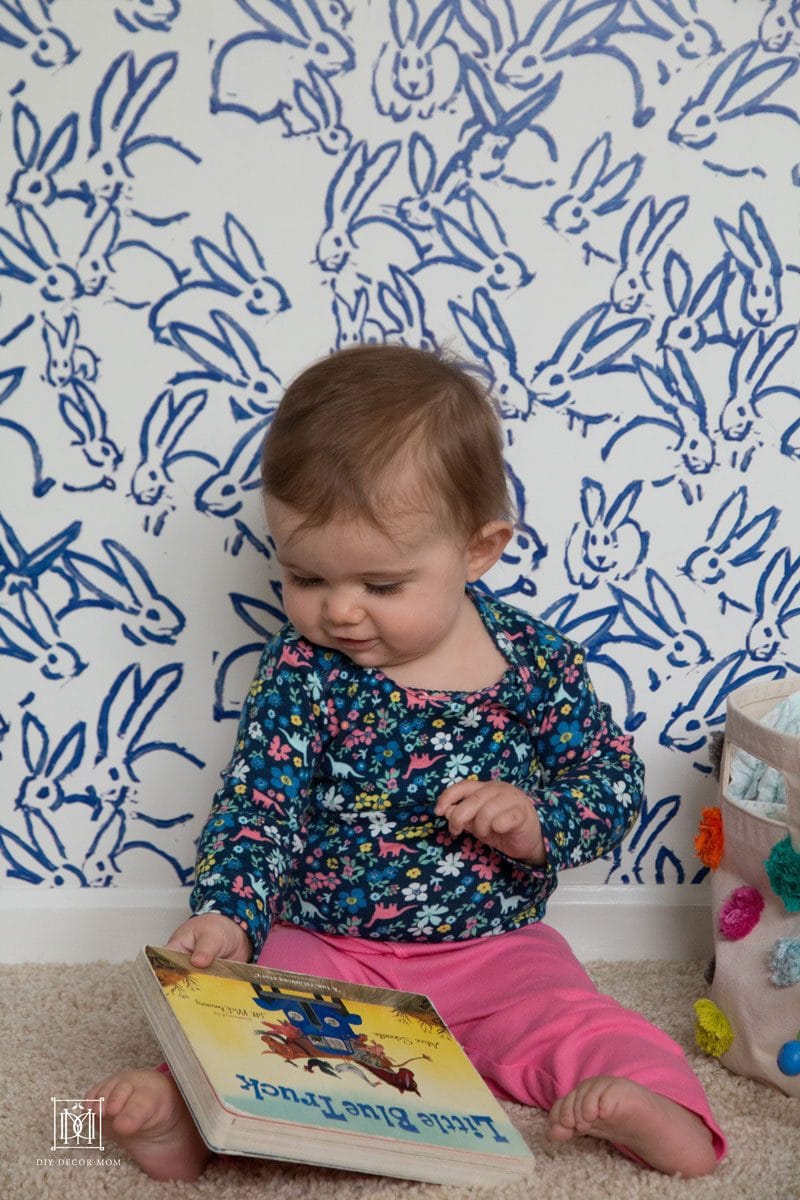 baby reading on floor of nursery- see more new mom tips here
