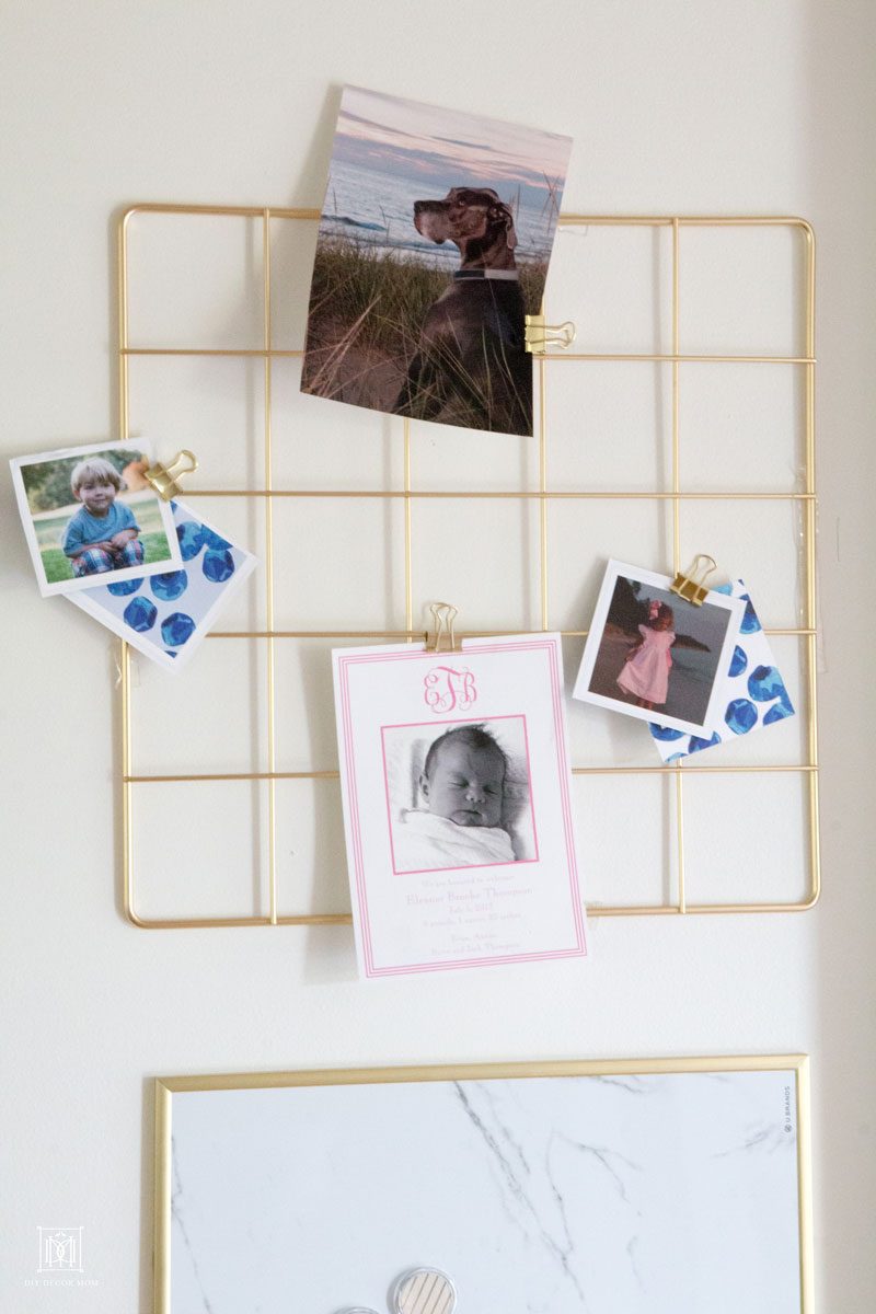 wire board with photos of children and birth announcements in family command center