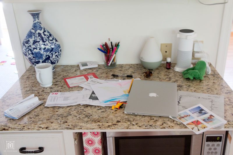 messy kitchen desk covered in papers