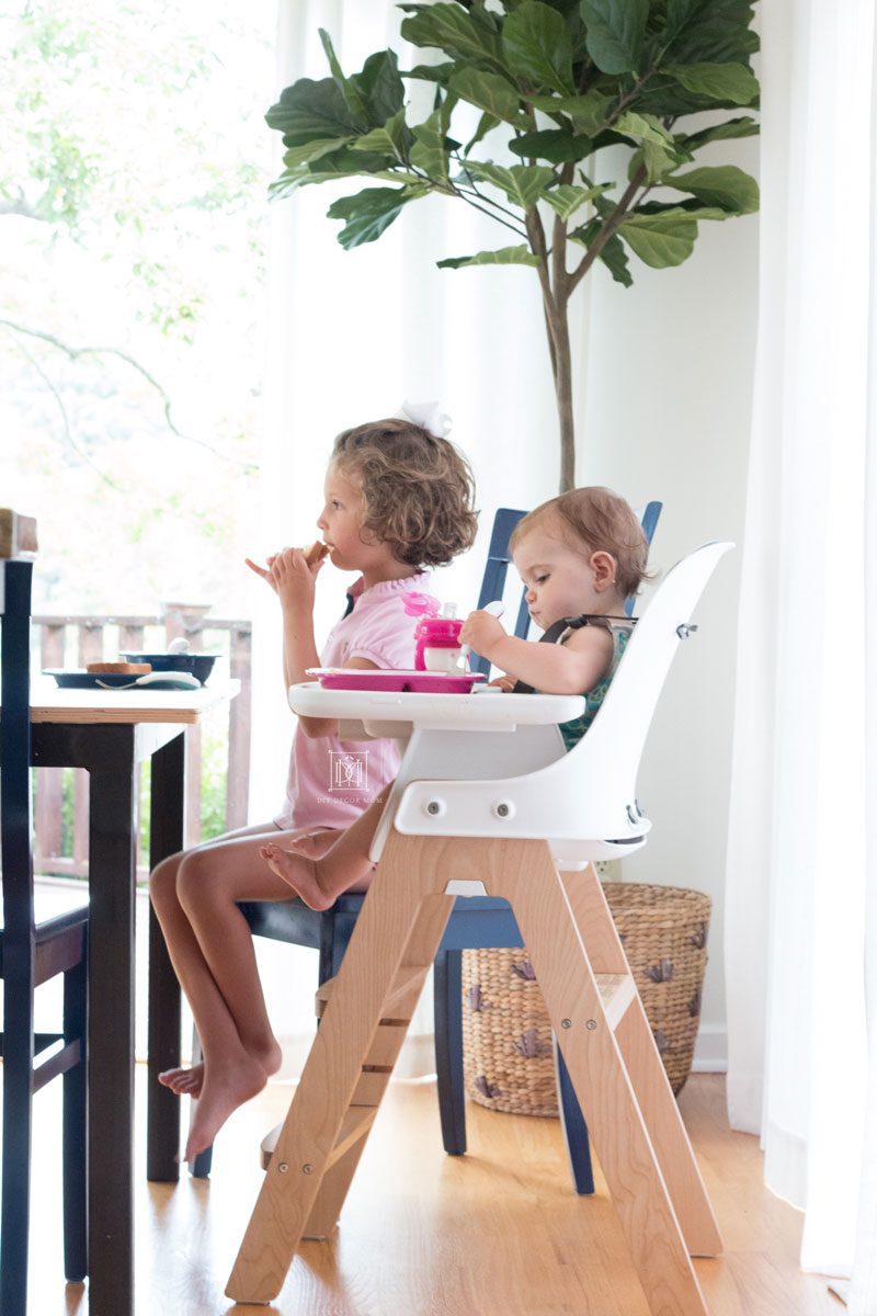 two girls sitting at a table- spring cleaning checklist and DIY recipes for cleaning dining chairs and high chairs