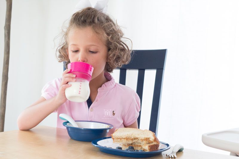 girl drinking from oxo transitions sippy cup