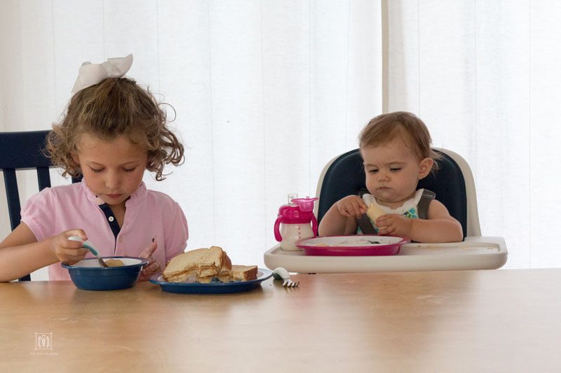 two sisters eating at dinner table