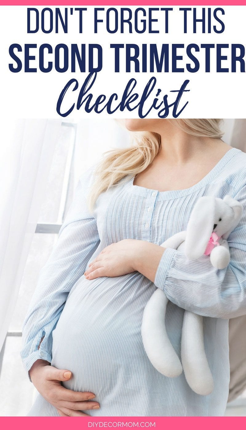 pregnant woman holding belly- second trimester things to do