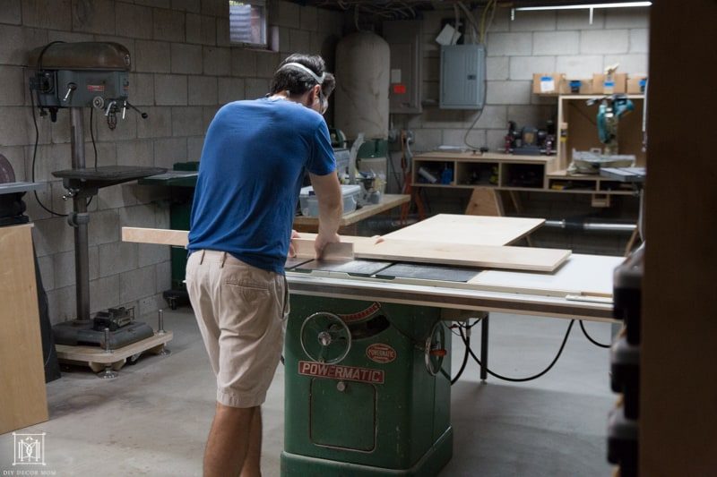 cutting a piece of plywood in workshop