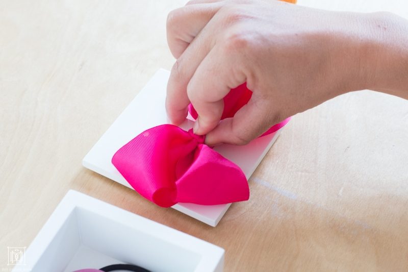 pink bow on white box